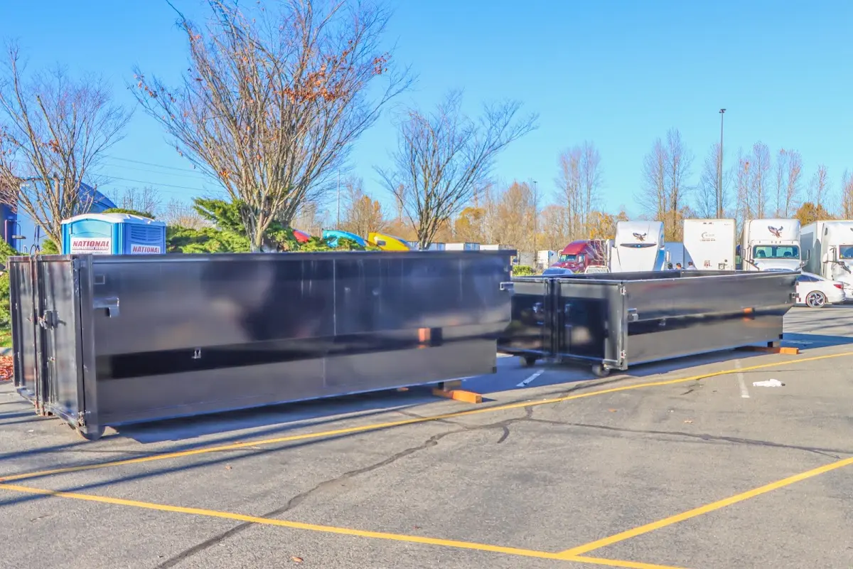 Professional dumpster rental service with roll-off container on residential driveway in Sinton